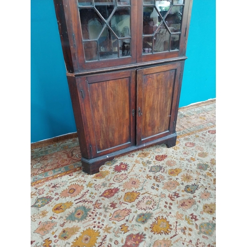 766 - Georgian mahogany corner cupboard the two astragal glazed doors over two blind doors raised on brack... 