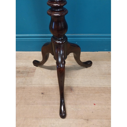 77 - Edwardian mahogany torchere raised on turned column and three outswept feet {122 cm H x 42 cm Dia.}.