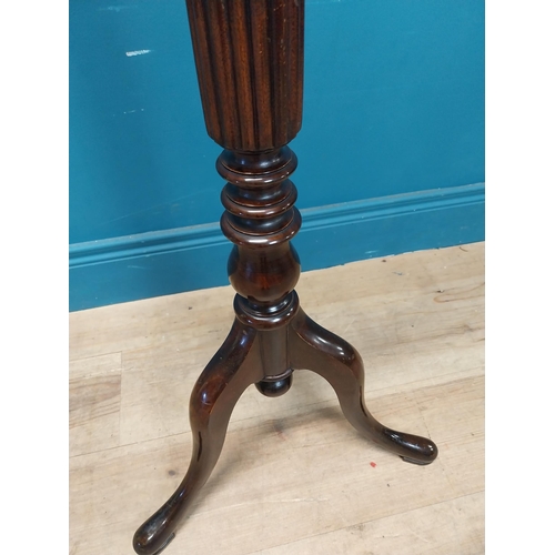 77 - Edwardian mahogany torchere raised on turned column and three outswept feet {122 cm H x 42 cm Dia.}.