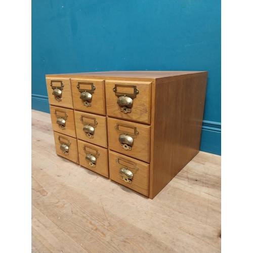 81 - 1940's oak desk top bank of drawers with original brass handles. {36 cm H x 50 cm W x 43 cm D}.