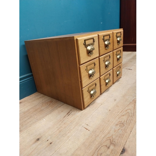 81 - 1940's oak desk top bank of drawers with original brass handles. {36 cm H x 50 cm W x 43 cm D}.