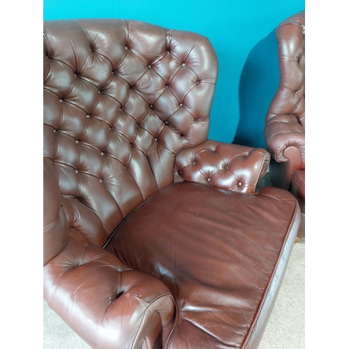 851 - Pair of deep buttoned leather wingback armchairs{109 cm H 98 cm W 76cm D}.