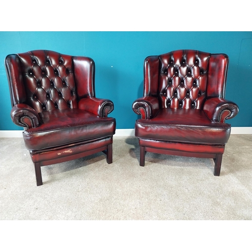 853 - Pair of deep buttoned leather wingback armchairs raised on square mahogany legs {102 cm H 82 cm W 80... 