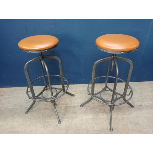 861 - Pair of metal swivel stools with leather upholstered seats. { 75cm H X 32cm Dia. }.