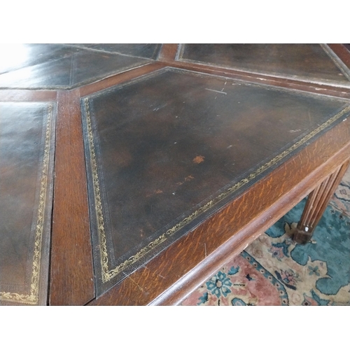 883 - 19th C. oak octagonal rent table with inset leather top raised on square reeded legs. Provenance fro... 