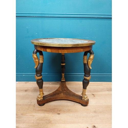 90 - Good quality gilt and ebonised walnut centre table with platform base on three carved legs in the Re... 