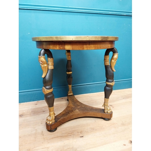 90 - Good quality gilt and ebonised walnut centre table with platform base on three carved legs in the Re... 