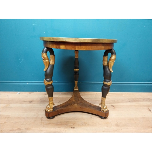 90 - Good quality gilt and ebonised walnut centre table with platform base on three carved legs in the Re... 