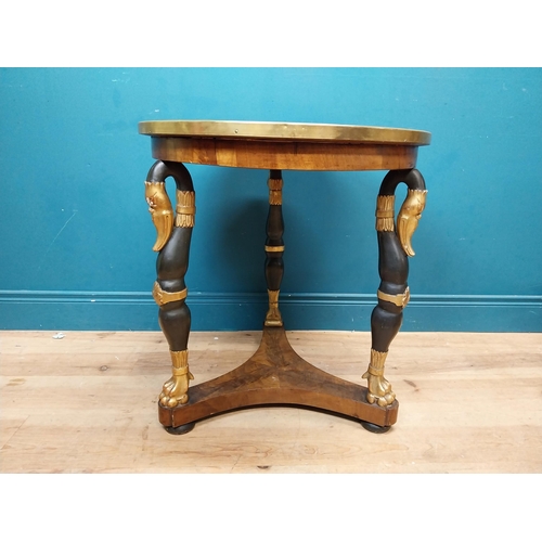 90 - Good quality gilt and ebonised walnut centre table with platform base on three carved legs in the Re... 