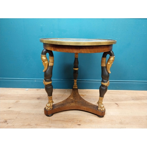 90 - Good quality gilt and ebonised walnut centre table with platform base on three carved legs in the Re... 