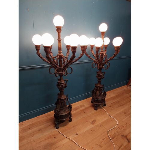 103 - Pair of decorative bronze floor candelabras with opaline glass shades {174 cm H x 75 cm Dia.}.