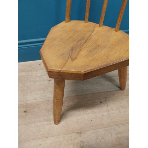 107 - 1950s pine childs chair raised on three tapered legs {74 cm H x 34 cm W x 37 cm D}.