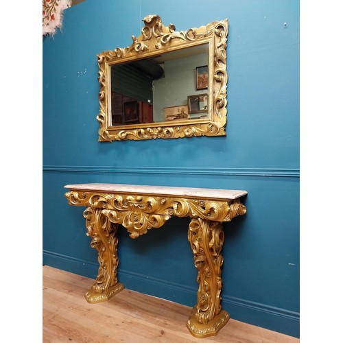 108 - Highly carved Gilt console table with marble top and matching mirror in the Rococo style. {87 cm H x... 