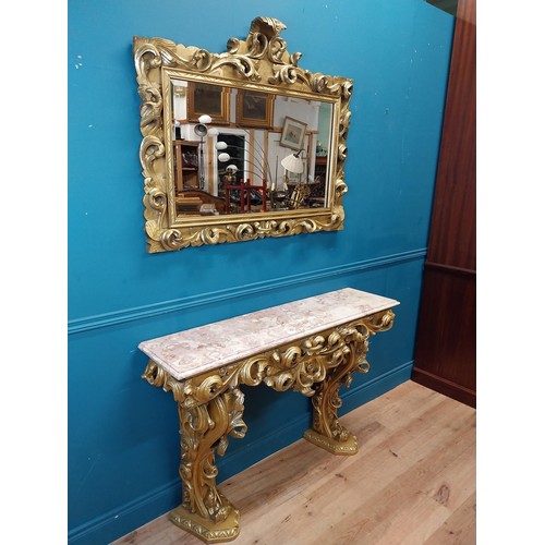 108 - Highly carved Gilt console table with marble top and matching mirror in the Rococo style. {87 cm H x... 