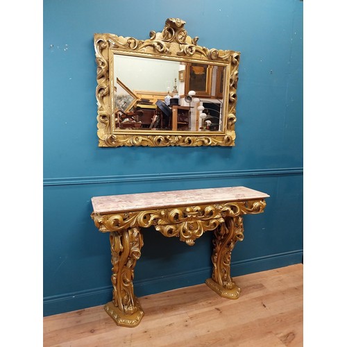 108 - Highly carved Gilt console table with marble top and matching mirror in the Rococo style. {87 cm H x... 