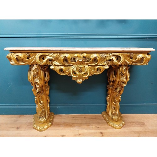 108 - Highly carved Gilt console table with marble top and matching mirror in the Rococo style. {87 cm H x... 