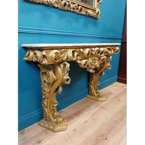 108 - Highly carved Gilt console table with marble top and matching mirror in the Rococo style. {87 cm H x... 