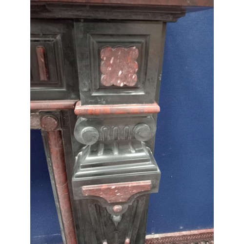 111 - Decorative 19th. C. black and maroon marble chimney piece, the legs in the form of  corinthain colum... 