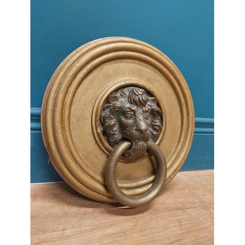 113 - 19th C. bronze door knocker, mounted on gilded circular wooden plaque {31 cm H x 30 cm W}.