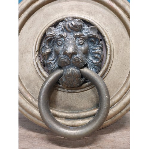 113 - 19th C. bronze door knocker, mounted on gilded circular wooden plaque {31 cm H x 30 cm W}.