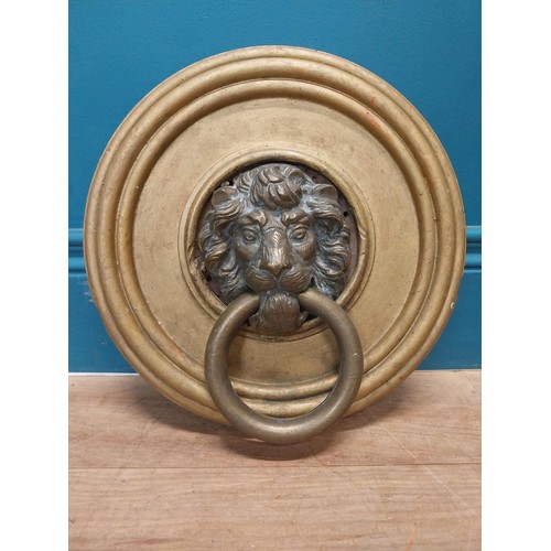 113 - 19th C. bronze door knocker, mounted on gilded circular wooden plaque {31 cm H x 30 cm W}.