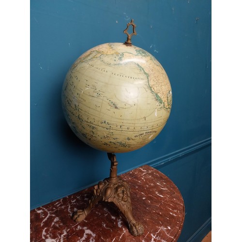 114 - Early 20th C. world globe on cast iron decorative tripos base. {58 cm H x 33 cm W  x 30 cm D}.