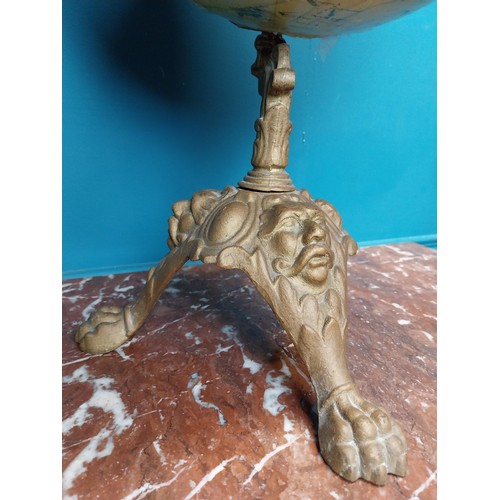 114 - Early 20th C. world globe on cast iron decorative tripos base. {58 cm H x 33 cm W  x 30 cm D}.