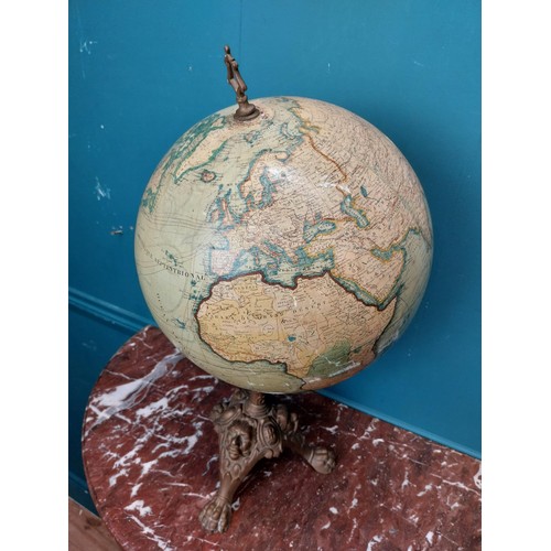 114 - Early 20th C. world globe on cast iron decorative tripos base. {58 cm H x 33 cm W  x 30 cm D}.