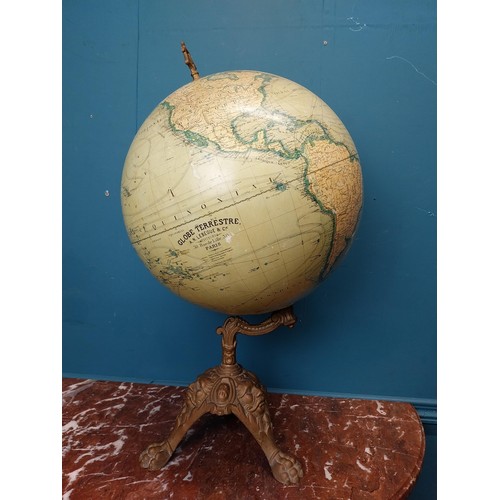 114 - Early 20th C. world globe on cast iron decorative tripos base. {58 cm H x 33 cm W  x 30 cm D}.