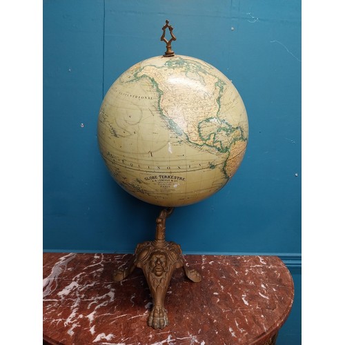 114 - Early 20th C. world globe on cast iron decorative tripos base. {58 cm H x 33 cm W  x 30 cm D}.