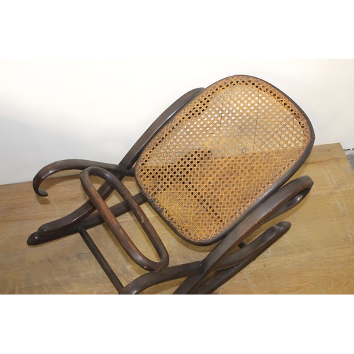 756 - Bentwood rocking foot rest with rattan base. { 40cm H X 67cm W X 38cm D }.