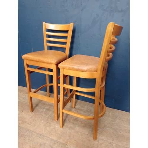 876 - Pair of breakfast bar stools raised on three legs. { 94cm H X 52cm W X 50cm D }.