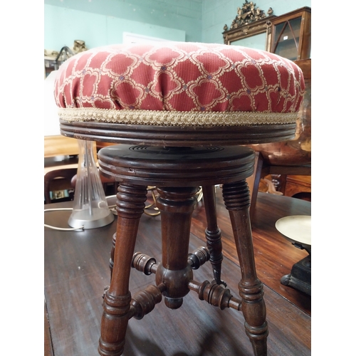 945 - 19th. C. revolving piano stool with upholstered seat raised on turned legs and claw feet.with glass ... 