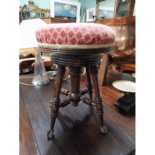 945 - 19th. C. revolving piano stool with upholstered seat raised on turned legs and claw feet.with glass ... 