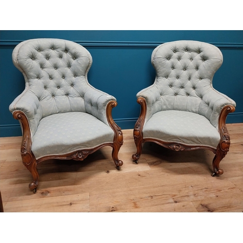 962 - Pair of mahogany and upholstered armchairs raised on cabriole legs {102 cm H x 78 cm W x 83 cm D}.