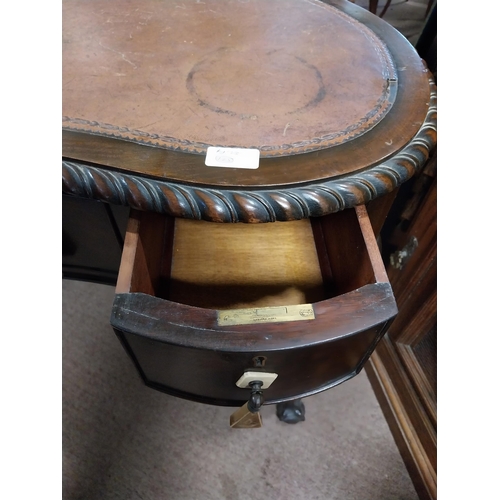 964 - Edwardian mahogany kidney shaped ladies desk with inset leather top {76 cm H x 92 cm W x 52 cm D}.