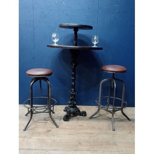 977 - Pair of metal industrial stools with leather upholstered seats. { 78cm H X 35cm Dia }.