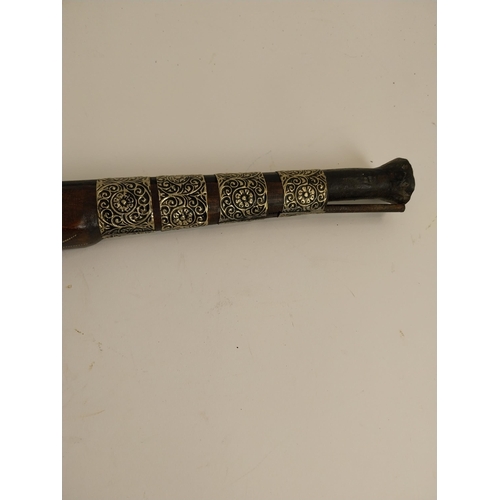 149 - Oriental percussion capped pistol with silver mounts. {47 cm H x 10 cm W}.