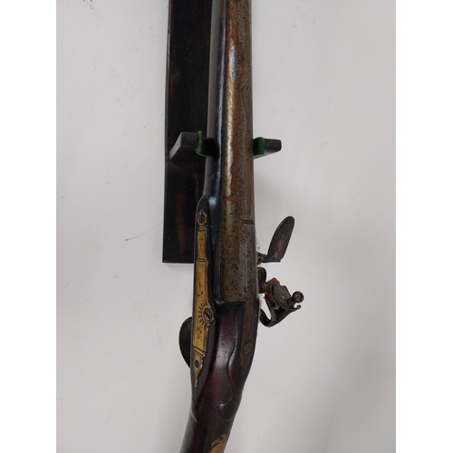 191 - 19th. C. flintlock single barreled sporting shotgun with walnut stock, brass mounts, chased action w... 