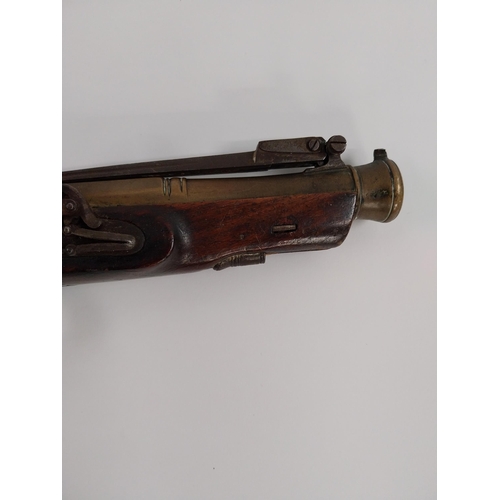 203 - 19th. C. flintlock pistol with brass barrel with sprung bayonet, walnut stock, chased action, ramrod... 