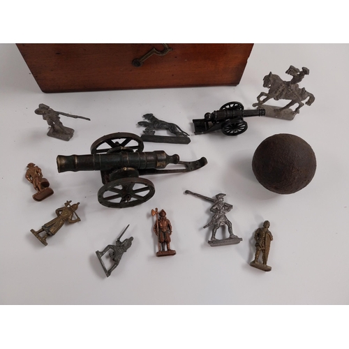 220 - Miscellaneous lot -  Small brass model of Cannon, cannon ball and soldiers in wooden box.