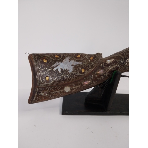 246 - Turkish flintlock blunderbuss inlaid with silver and mother of pearl on stand. {88 cm L x 18 cm W}.