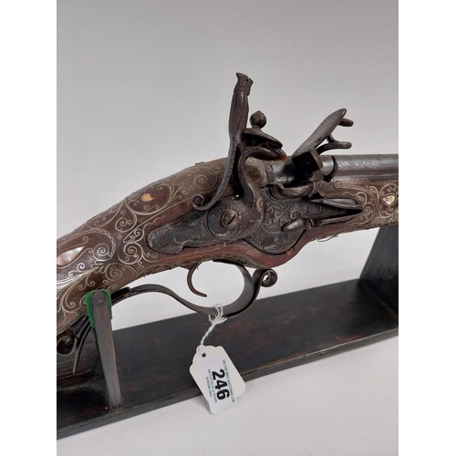 246 - Turkish flintlock blunderbuss inlaid with silver and mother of pearl on stand. {88 cm L x 18 cm W}.