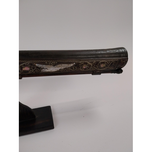 246 - Turkish flintlock blunderbuss inlaid with silver and mother of pearl on stand. {88 cm L x 18 cm W}.