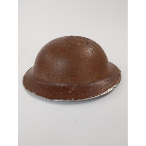 248 - WWII. British army helmet with liner and chin strap.