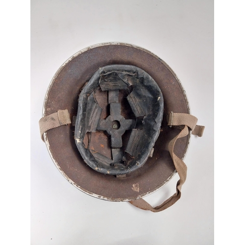 248 - WWII. British army helmet with liner and chin strap.