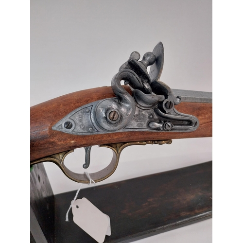 251 - Replica flintlock rifle. {147 cm L x 15 cm H}.