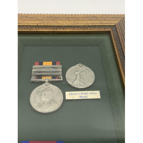 396 - Set of replica Waterloo & Queen's South Africa medals with ribbons mounted in a glazed case.