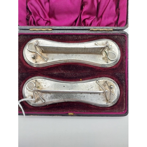 494 - Unusual Pair of Silverplated knife rests in the form of tennis nets with raquets & balls