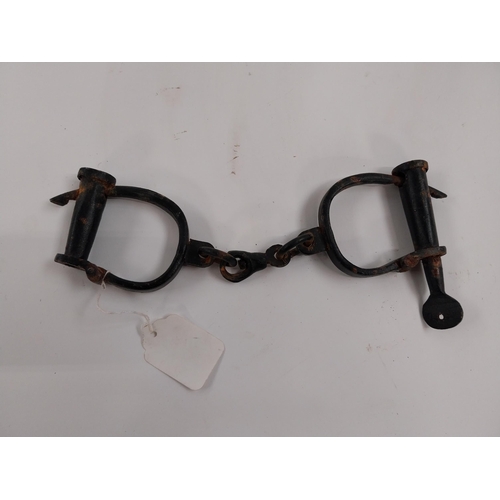 63 - Pair of RIC handcuffs. {28 cm L}.